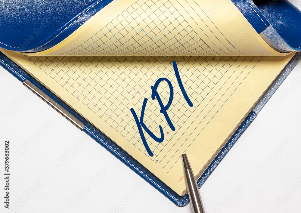 Poster text kpi acronym in notebook on a white table close up