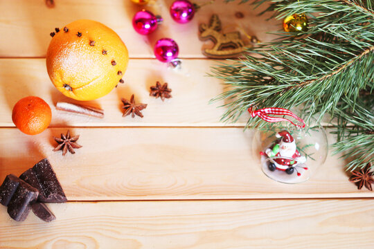 Pine branch, chocolate, orange and beautiful Christmas decorations