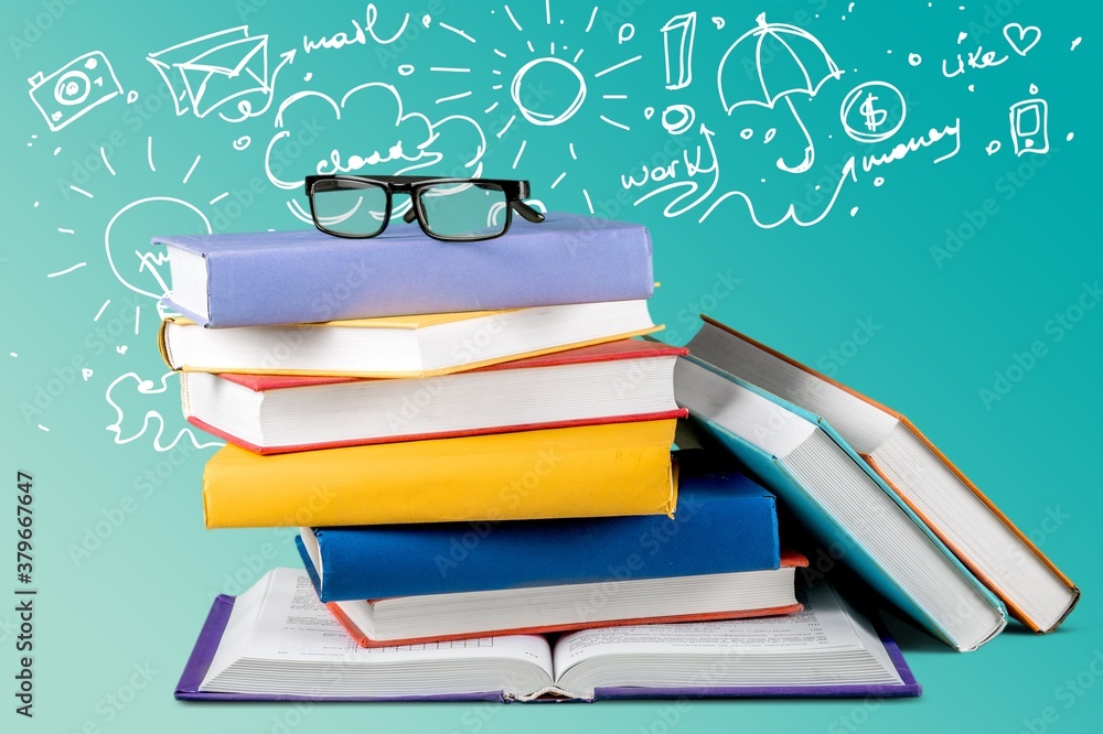 Poster stack of books with reading glasses on table