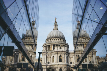Saint Paul Cathedral reflected in modern glass walls of One New Change mall in City of London, England