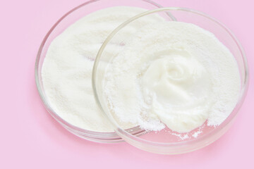 Collagen white powder. Pastel color background. Health product. Woman cosmetics concept. Sport supplement. Skincare cosmetics. Pink monochrome