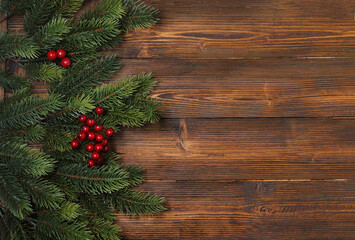 New Year and Christmas mock-up with fir tree branches and red and golden decorations on the wooden background