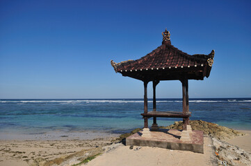 Beach hut in traditonal Balinese roof style at Pandawa Beach, Bali, Indonesia.