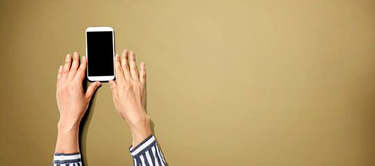 Obraz na płótnie Canvas Person using a white smartphone from above