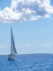 Fototapeta premium Sailboat anchored at the sea during summer vacation. Fun and adventure vacations in the ocean with friends.