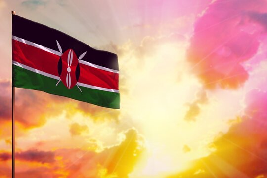 Fluttering Kenya flag in top left corner mockup with the space for your text on beautiful colorful sunset or sunrise background.
