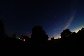 Blue dark night sky with many stars. Night sky over rural landscape. high ISO landscape with...