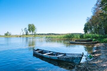 Naklejka na ściany i meble Old wooden boats on the Strusto lake. View of the third largest among the Braslav lakes. Braslav. Belarus