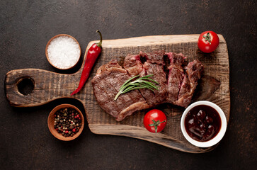Fototapeta na wymiar grilled marbled beef steak with spices on background stone