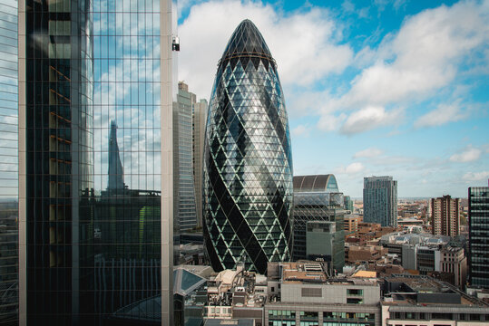 London, UK - October 18, 2019: View of buildings of London with the famous 30 St Mary Axe Building, also known as the Gherkin, in the center of the image.