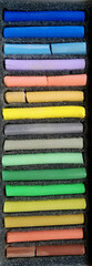 set of multicolor dry pastel crayons in container