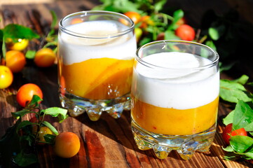 Peach smoothie on a wooden table on a Sunny day.