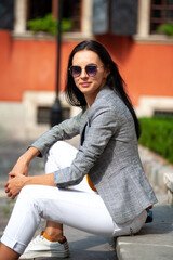 Young beautiful woman in sunglasses in the city