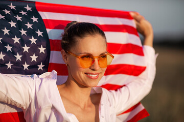 beautiful young female in pink glasses
with american flag