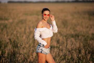 beautiful young woman in pink glasses in summer