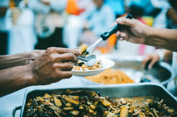 Fototapeta premium Receiving food for the poor from volunteers : Concepts of poverty