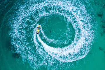 People are playing a jet ski in the sea.Aerial view. Top view.amazing nature background. The color...