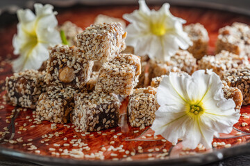 Obraz na płótnie Canvas Turkish delight sprinkled with sesame seeds on a beautiful plate