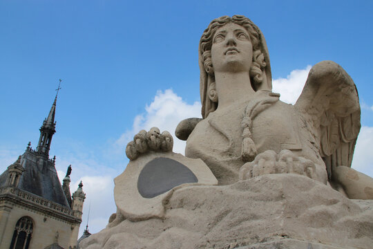 statue of a sphinge and chapel in chantilly (france)