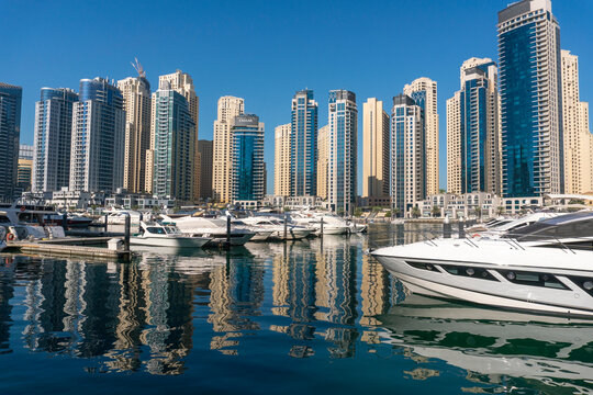 Jacht and Skyscrapers Above the Water of Persian Gulf in Dubai Marina District in UAE