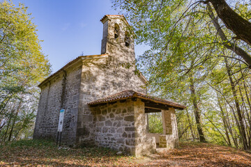 View of small cute Church of the Three Kings in the wood near Castelmonte, Prepotto, Friuli rgion, Italy