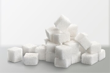 White cubes of sugar on a blur background