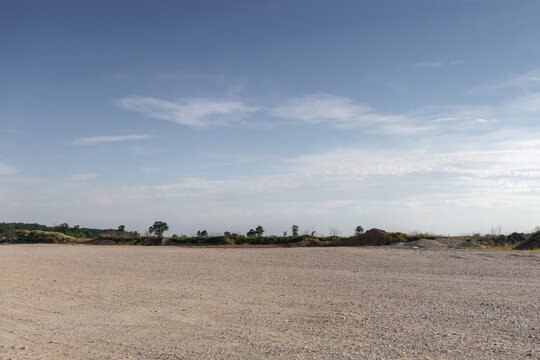 Large gravel background site with cloudy sky