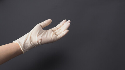 hand wear white latex gloves and hold hands on black background.