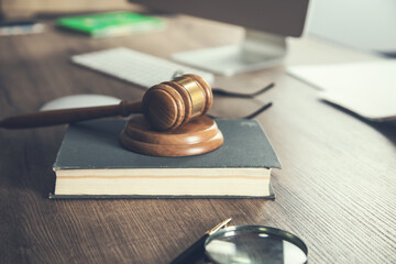 Judge gavel and book on wooden desk