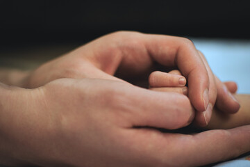 Newborn and parent hands