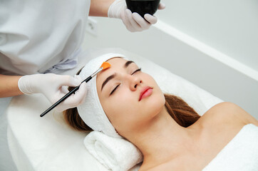 Obraz na płótnie Canvas Woman getting face beauty treatment procedure in medical spa center