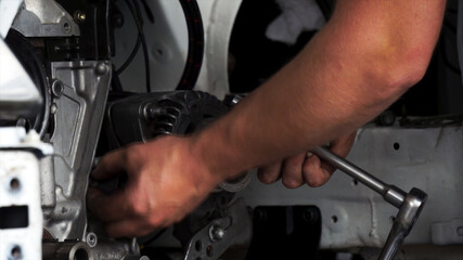 Professional mechanic fix a car engine in repair shop. Footage. Closeup view auto service, repair and maintenance