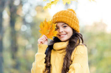 Feeling the nature. knitwear warm you in any weather. girl in yellow sweater and hat. kid enjoy...