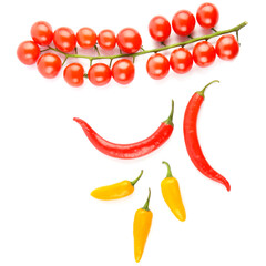 Cherry tomatoes, cayenne and chili pepper isolated on white. View from above.