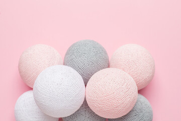 Pink, grey and white balls on a pastel background