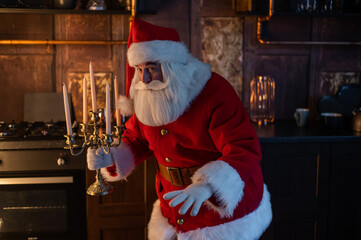 Santa claus sneaks up at night and holding a candelabrum.