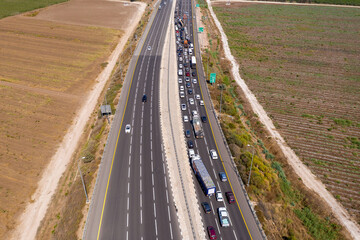 Police roadblock on a highway, with traffic at full stop, Aerial view.
