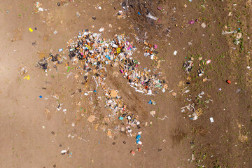 Piles of trash scattered in a large field, Aerial view.