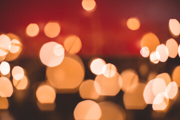 Defocused abstract bokeh lights background. orange, red, black colors. christmas and new year concept
