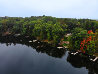 An aerial view of rural Northern Wisconsin forest, cabins and lake