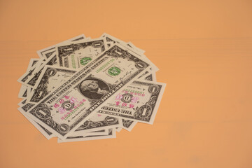 Dollar money placed on orange background