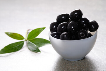 Tasty black olives in the bowl