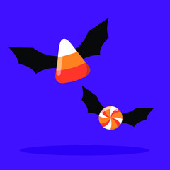 Halloween fancy candy with bat wings flying on purple background.Candy,Candy corn
