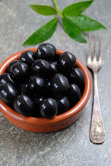Tasty black olives in the bowl