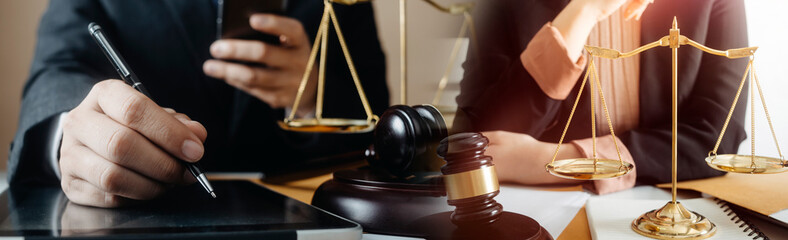 Business and lawyers discussing contract papers with brass scale on desk in office. Law, legal...