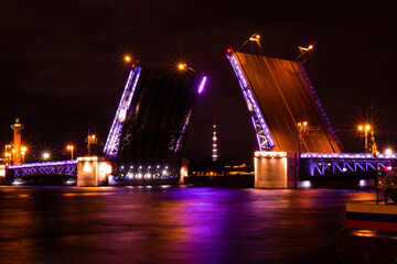 Fototapeta na wymiar Colorful night view on opening of Palace drawbridge in Saint Petersburg, Russia. Raising the moveable bridge in the nighttime