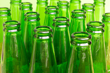 Background with empty green glass bottles