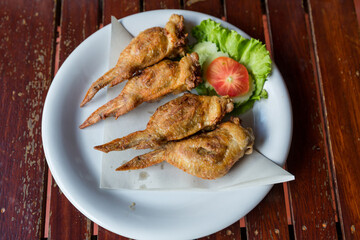 Fired Chicken wings marinated in traditional. lots of fired chicken wing on plate. Chicken fired unhealthy food.