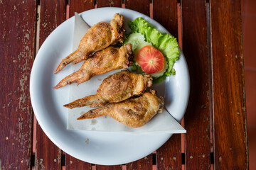 Fired Chicken wings marinated in traditional. lots of fired chicken wing on plate. Chicken fired unhealthy food.