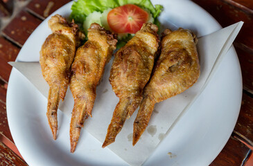 Fired Chicken wings marinated in traditional. lots of fired chicken wing on plate. Chicken fired unhealthy food.